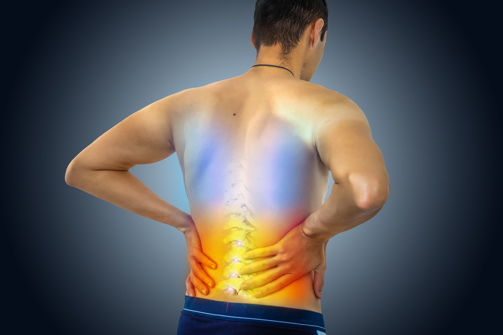 Lower back pain. Man holding his back in pain. Medical concept.